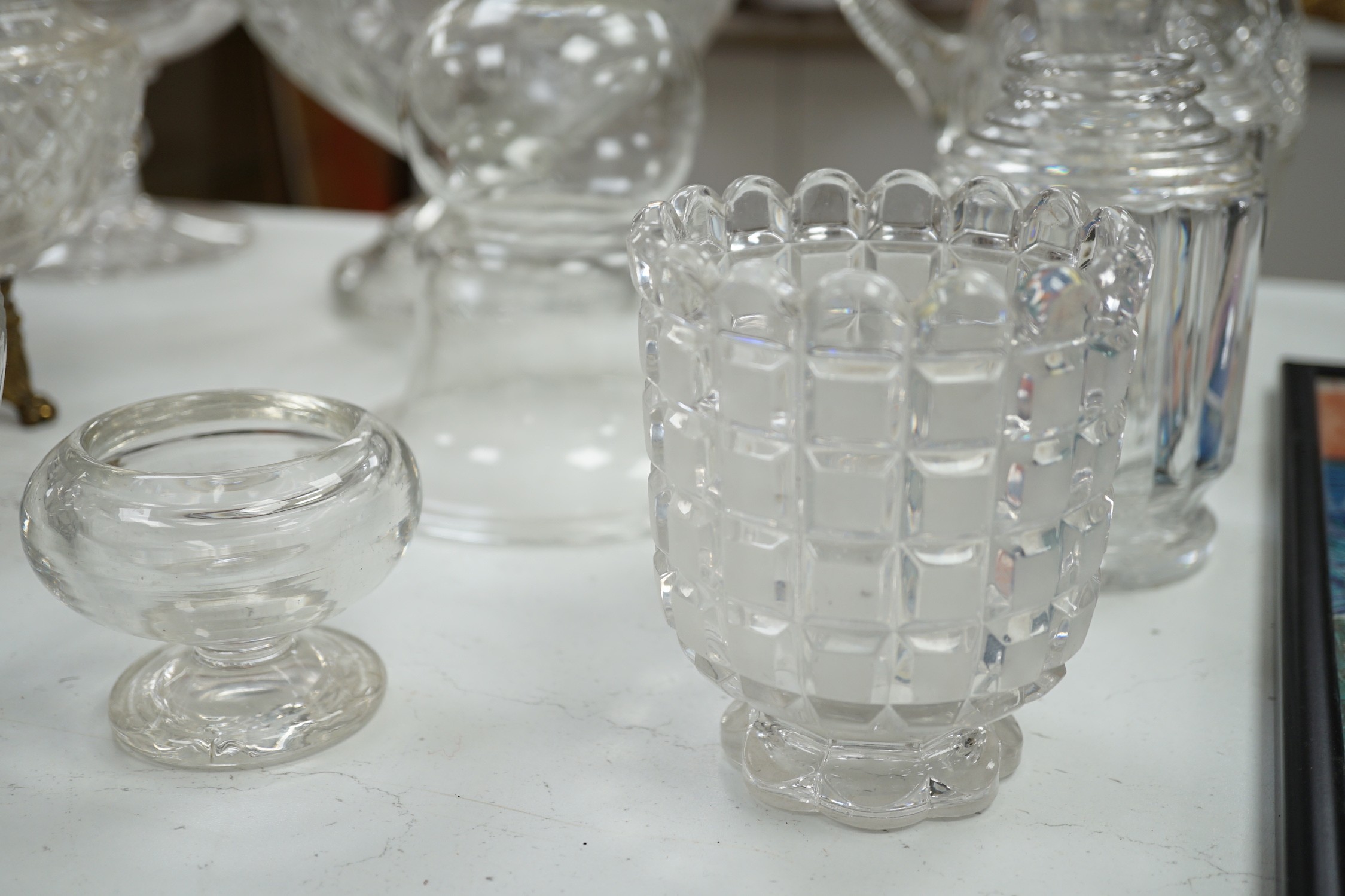 An early 20th century oval cut glass bowl on gilt metal stand, a pair of slice cut decanters and stoppers, a blown glass smoke bell two bowls and four other items of glassware, tallest 26 cm